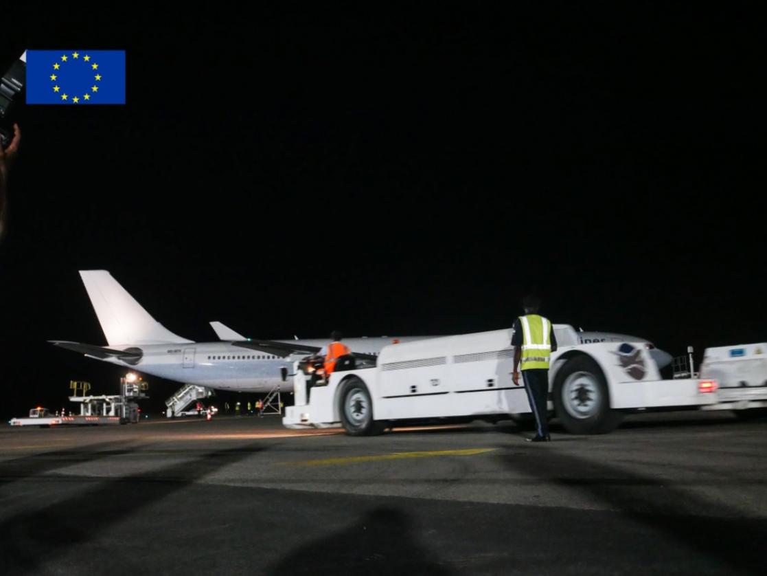 Runway in which there is a car and plane
