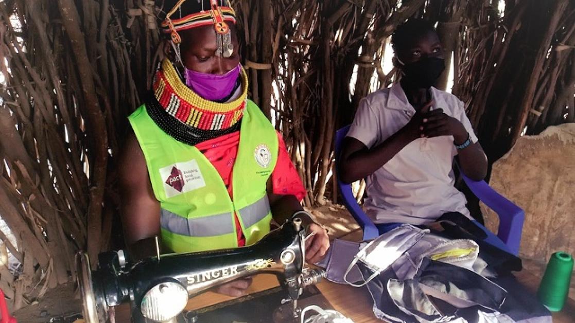 People working in a hut