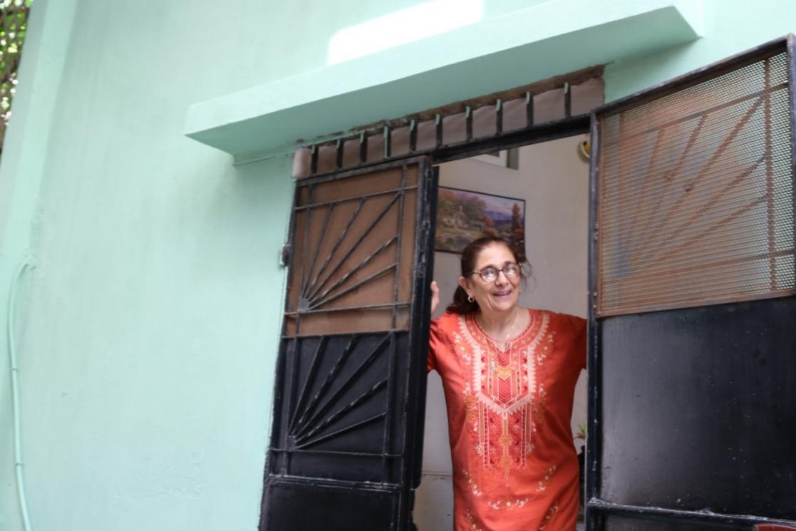 woman on a front door of a house 