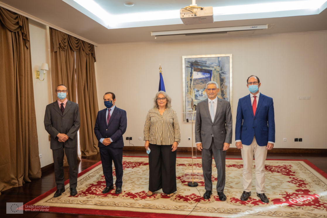 Woman and four men posing