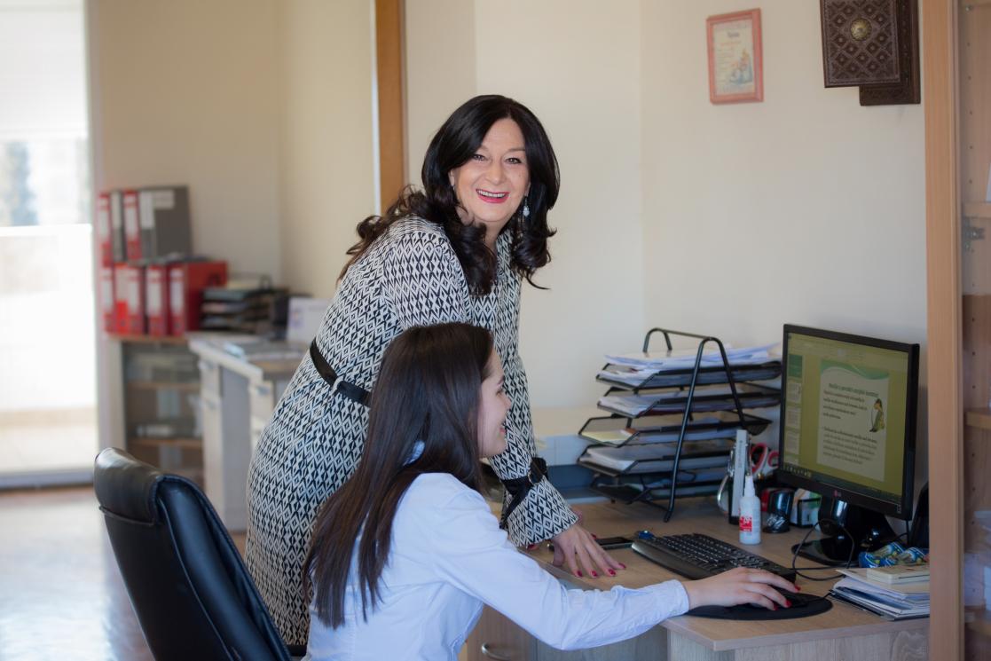 Woman with a girl using the computer
