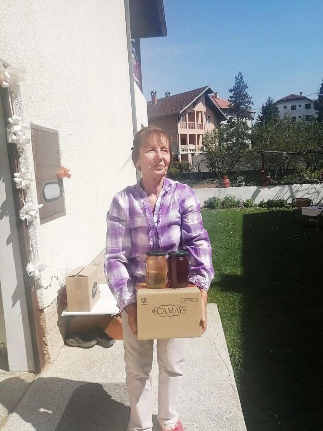 Woman with a box and two bottles
