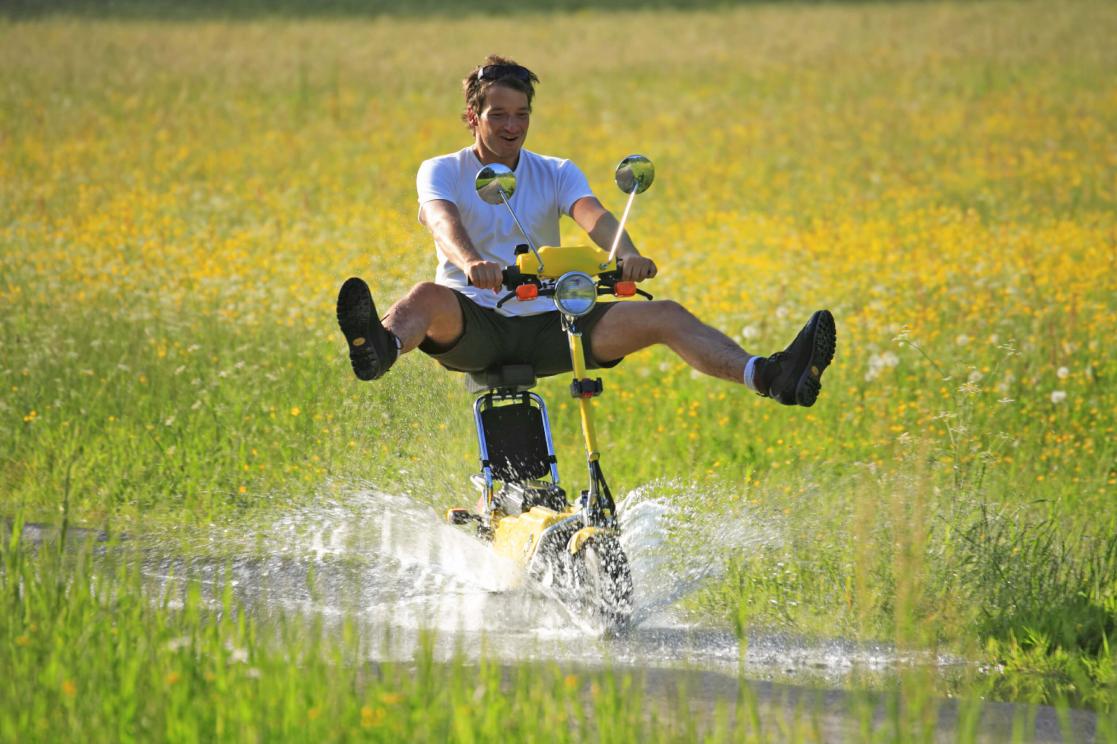 Man ridding a bike in the field