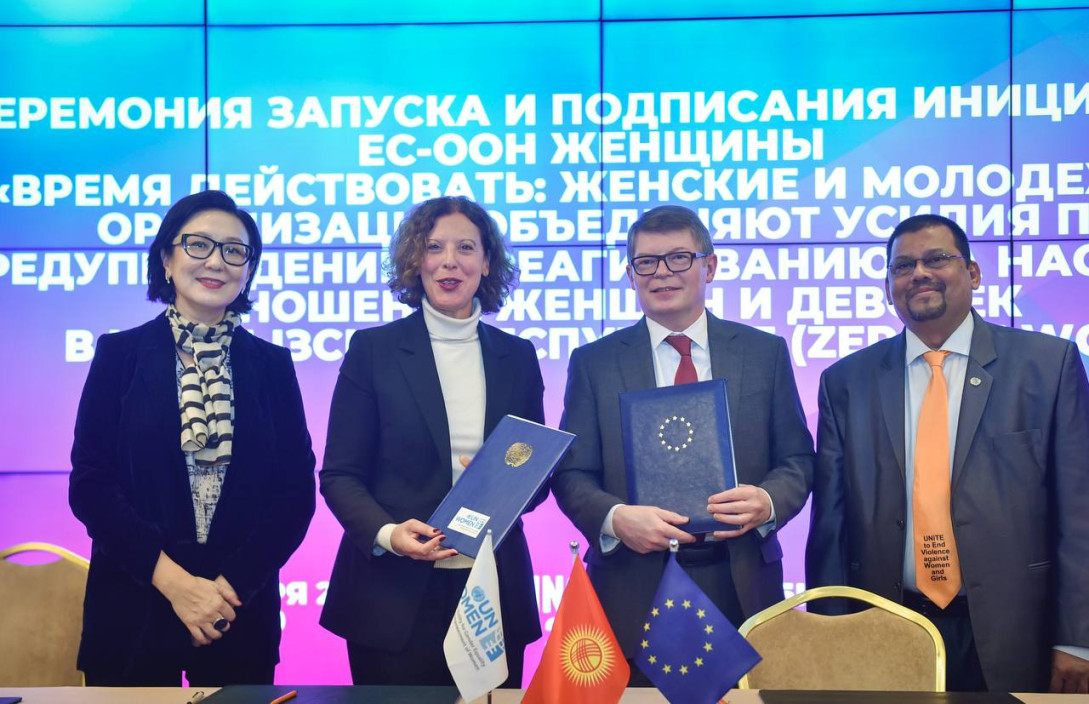 4 people standing on front of a digital banner