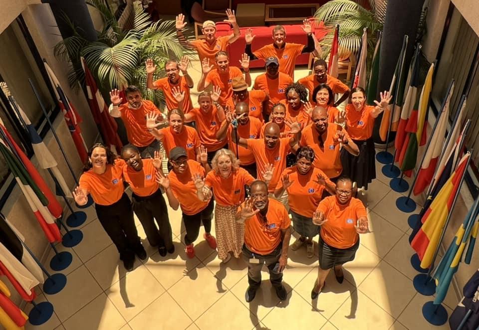 EU Delegation of Botswana staff and colleagues wearing ornage tops, stand against GBV