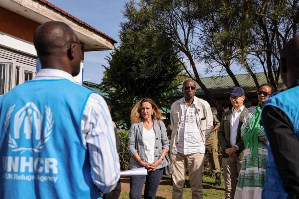 (from back left-right) Myriam Ferran, the European Union (EU) Deputy Director General for International Partnerships (EU-INTPA), UNHCR’s Assistant High Commissioner (Operations) Raouf Mazou and EU Ambassador to Uganda Jan Sadek, at a briefing at the Rubondo health centre in the Nakivale settlement, south-western Uganda.  © UNHCR/Esther Ruth Mbabazi