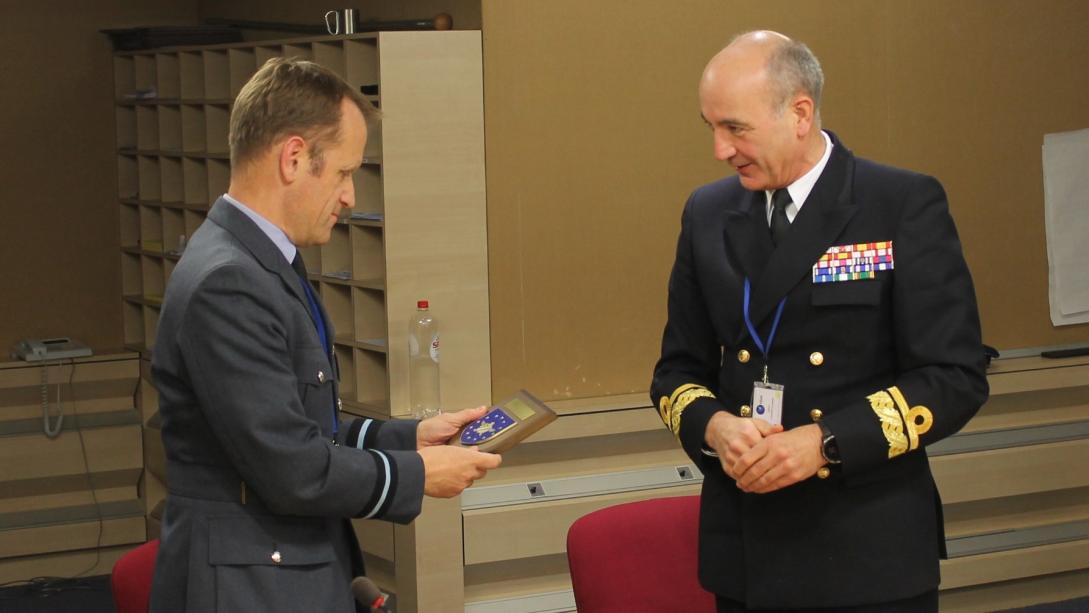 Rear Admiral Ignacio Cuartero Lorenzo make a presentation to Air Commodore Stephen Kelvington at the conclusion of the visit of the National Military Representative delegation SHAPE to the EUMS.