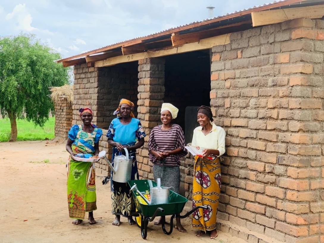 Members of Tithetse VSL outside their oven