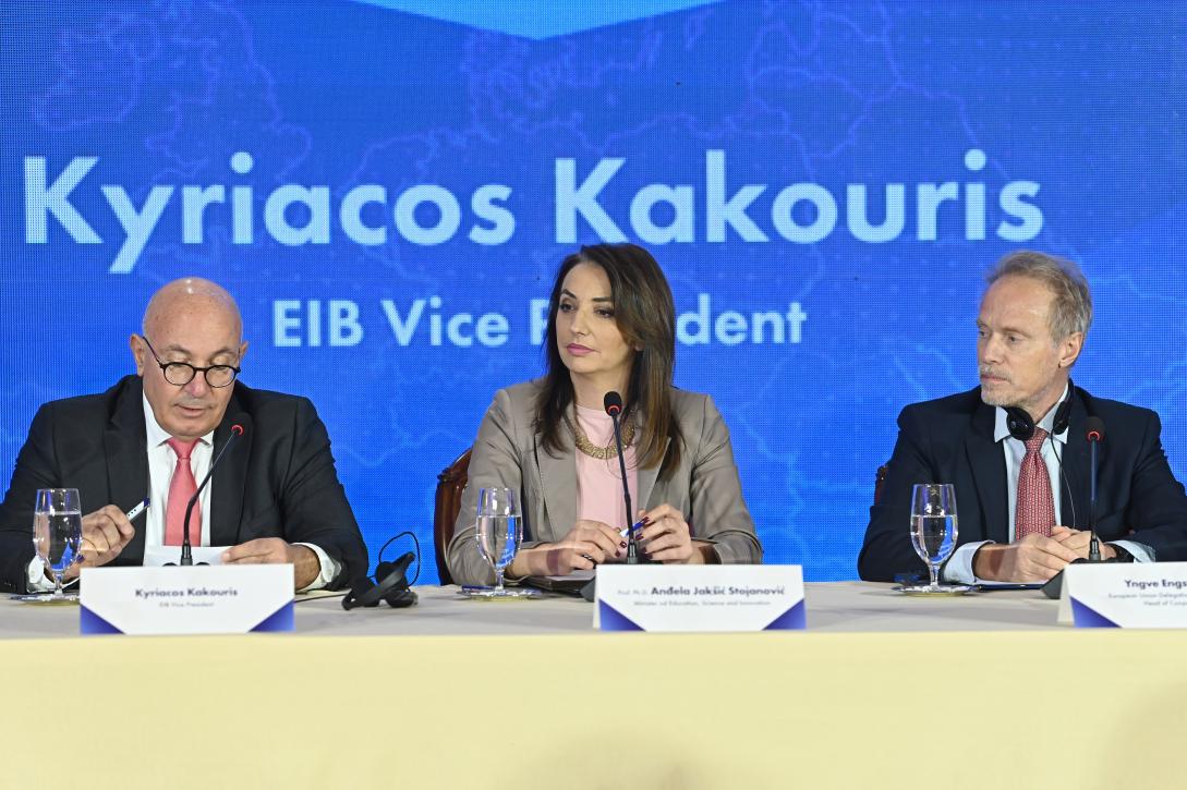 EIB Vice-President Kyriacos Kakouris, Minister of Education, Science and Innovation Anđela Jakšić-Stojanović and Yngve Engstrom, Head of Cooperation at the EU Delegation to Montenegro sitting. Behind them is a blue screen with EIB Vice-President Kyriacos Kakouris written on it