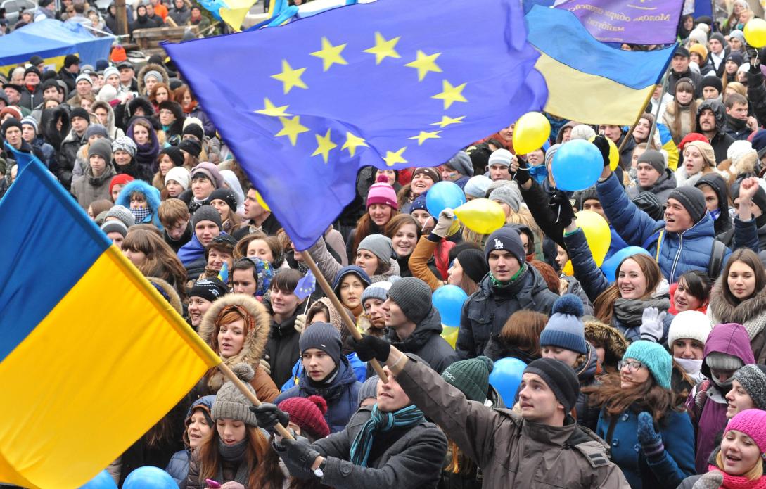  Students wave Ukrainian and European Union flags on December 5, 2013