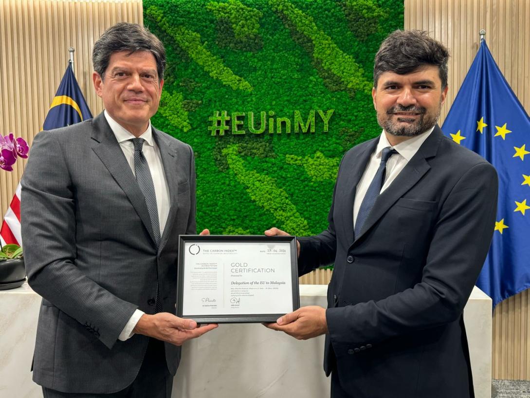 EU Ambassador Rokas displaying latest suistainability certificate