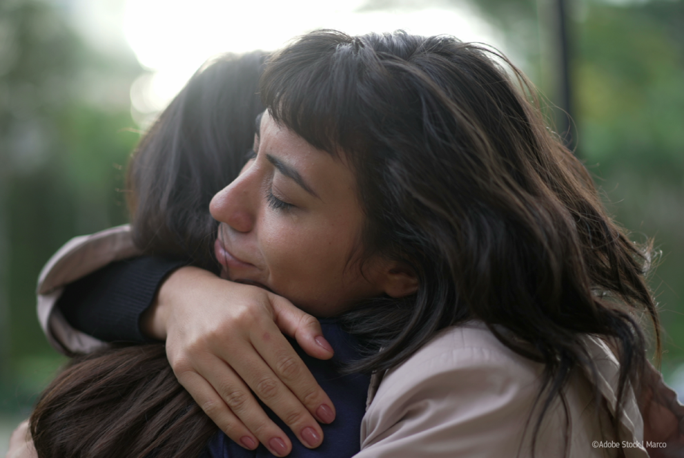 Closeup of two people hugging