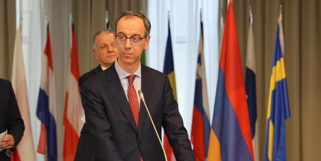 Stefano Tomat in an event with flags behind him