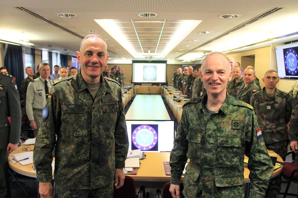 EU military commanders and staff in operations HQ, smiling for camera.