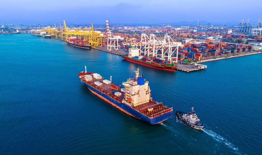 A cargo ship docking in a busy port.