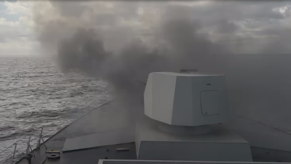 Rear view of a naval gun firing .