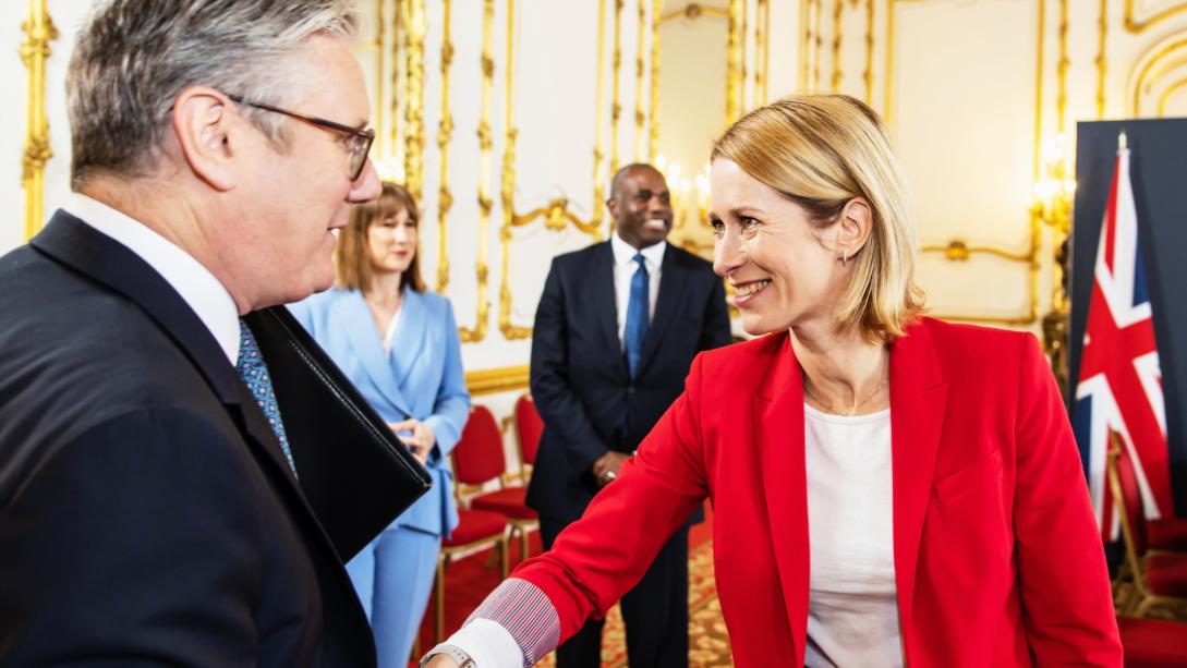 Foreground, Keir Starmer, UK PM, meets and greets HRVP Kaja Kallas, other dignitaries in background.