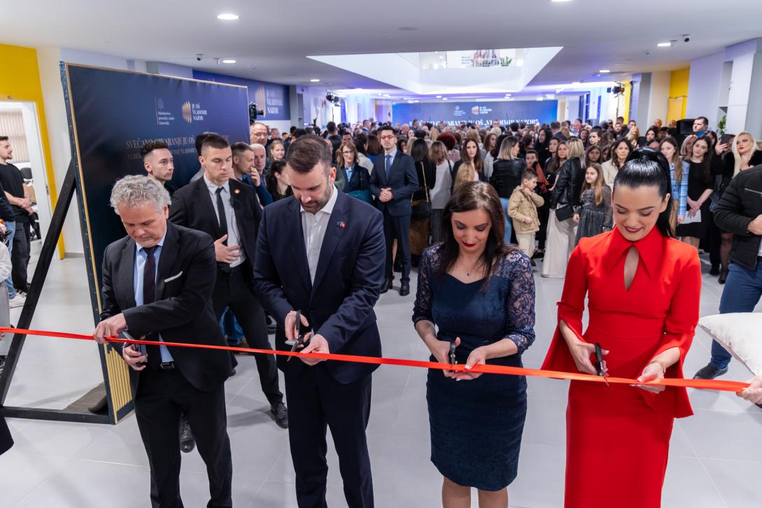Ambassador, Prime Minister, Minister of Education, and School Director cutting ribbon