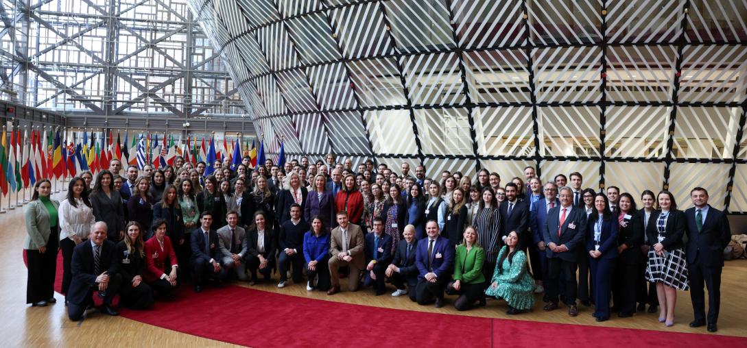 A large group photo taken in a European Union building