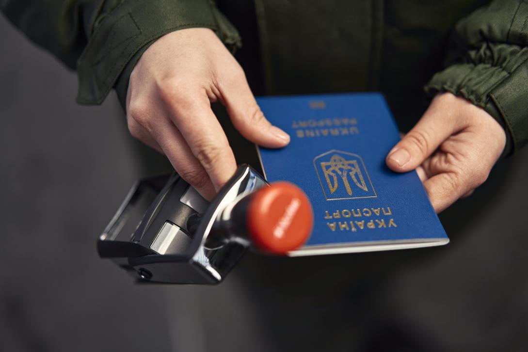 Hands with the Ukrainian passport