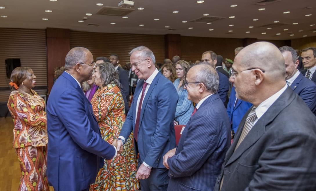 Group of men greeting each other with shaking hands
