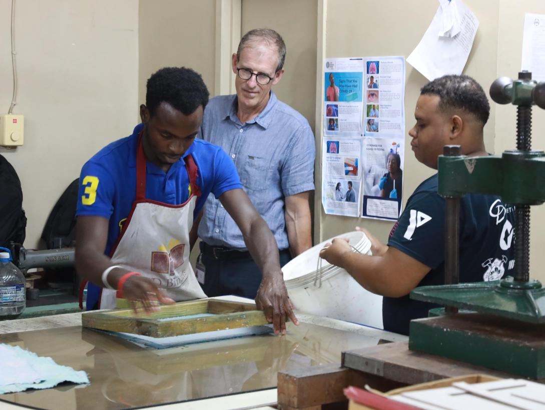 Shawn Jones assists his coworker, Onindia McNamee (left) who is showing programme officer, EU Jamaica delegation to Jamaica, André Fache Shawn Jones assists his hearing impaired coworker, (left) Onindia McNamee who is showing Programme officer for the EU delegation to Jamaica,  André Fache how to make recycled paper. 
