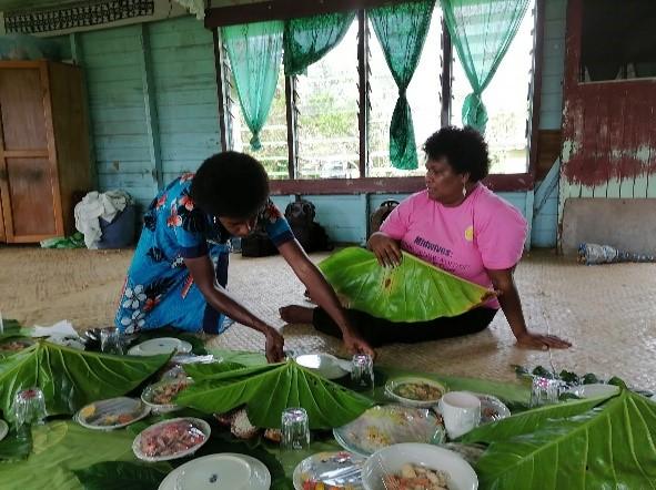 Two women prepapring food.