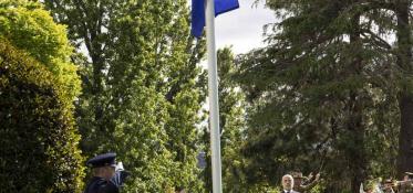 Soldier salutes European Union Flag being raised