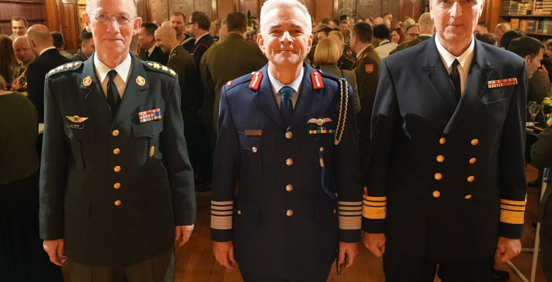 Three people in uniform in front of the camera