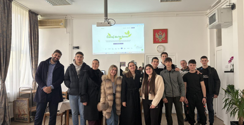 Vuk Vujisic standing with a group of pupils