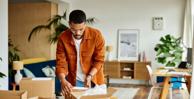 A man standing and packing 