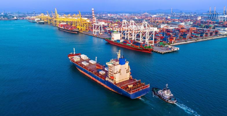 A cargo ship docking in a busy port. 