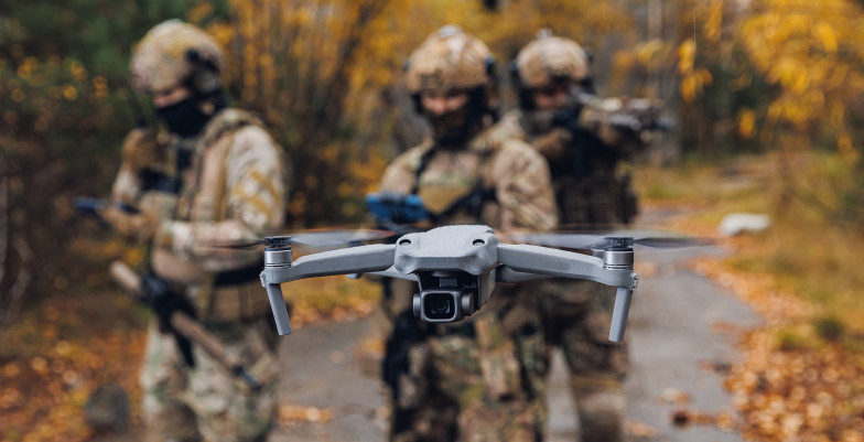Modern army soldiers using aerial drone for artillery guidance