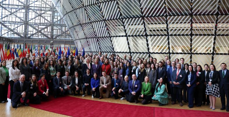 A large group photo taken in a European Union building