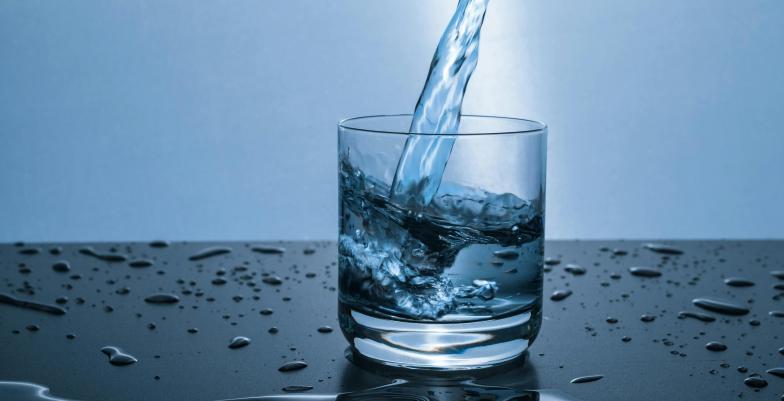 A glass of water getting filled
