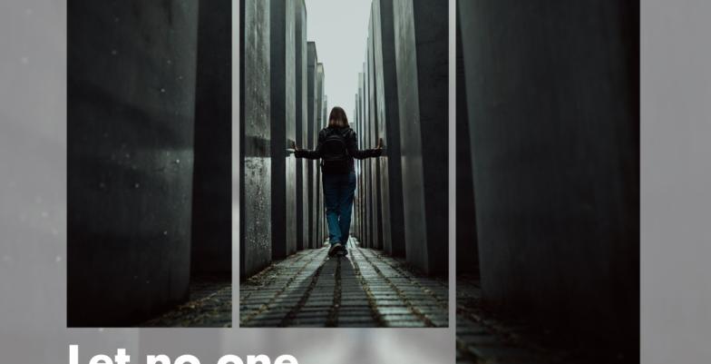 Silhouette of person walking through Holocaust memorial