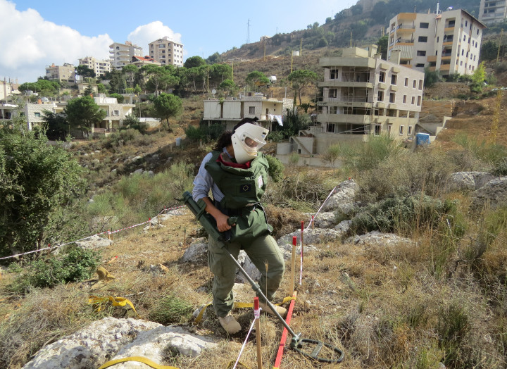 DCA Female deminer using the Vallon detector to locate land mines