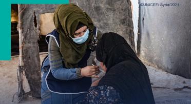 Woman vaccinating another woman on her shoulder