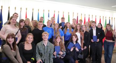 Group of people, some wearing bright blue EU tshirts