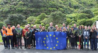 tree planting event participants holding an EU flag
