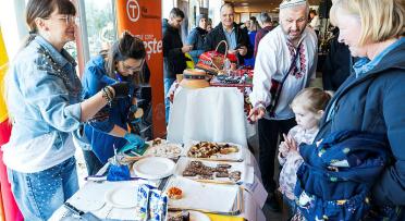 Picture of people receiving snacks at a Romanian booth at Europe Day 2025