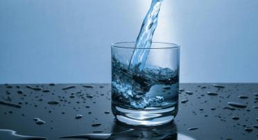 A glass of water getting filled