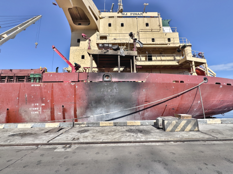 A burned out grain ship dockside in Ukraine.