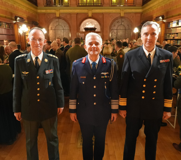 Three people in uniform in front of the camera