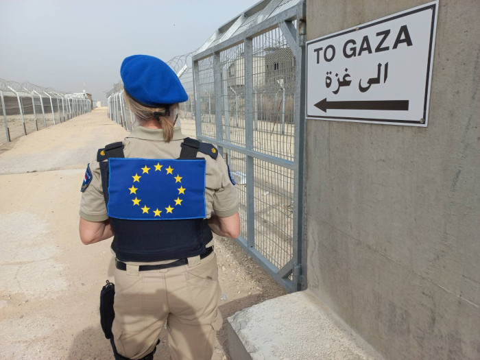 An officer is vigilant at the crossing point. 