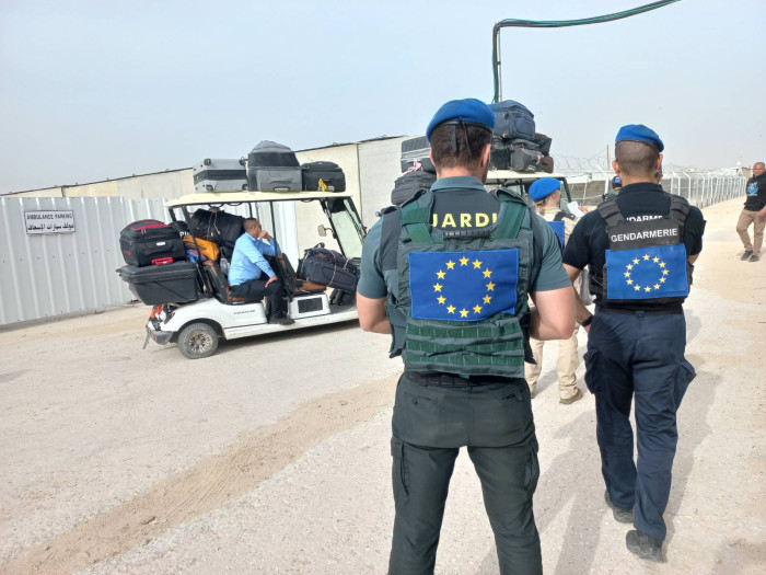 Officers observe a cart at the crossing. 