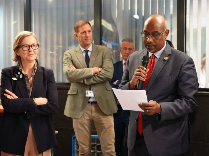 Group photo of three VIP attendees at opening. 