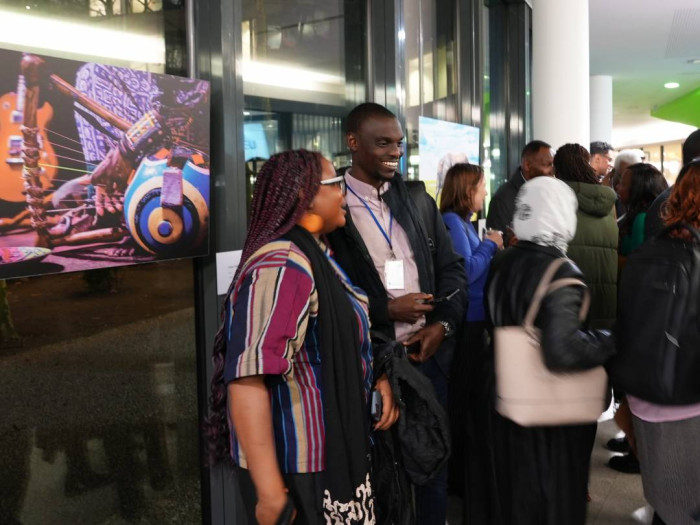 Two attendees near an art exhibition. 