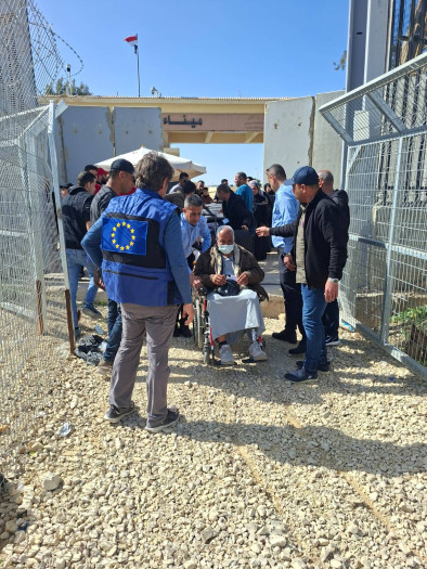 Welcoming a man in a wheelchair at the checkpoint. 