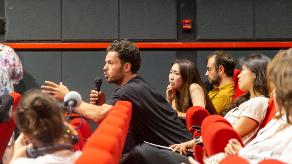Person in audience with microp[hone asking quesitons.